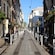 Historic homes, shops and flower baskets lining a narrow street